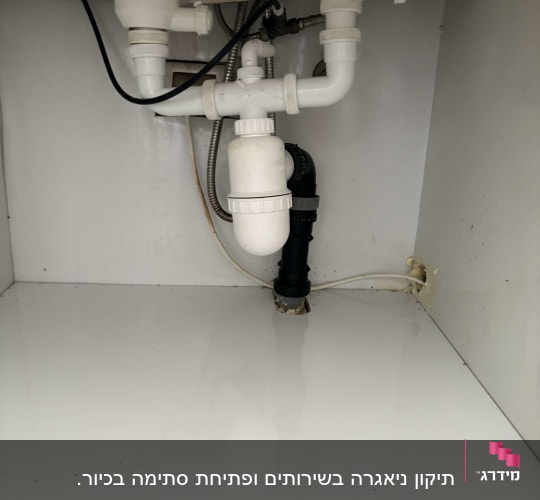 צנרת פלסטיק לבנה מתחת לכיור עם חיבורים
